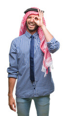 Wall Mural - Young handsome arabian business man wearing keffiyeh over isolated background doing ok gesture with hand smiling, eye looking through fingers with happy face.