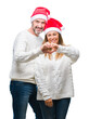 © Krakenimages.com - Middle age hispanic couple wearing christmas hat over isolated background smiling in love showing heart symbol and shape with hands. Romantic concept.