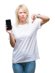 Sticker - Young beautiful blonde woman showing screen of smartphone over isolated background with angry face, negative sign showing dislike with thumbs down, rejection concept