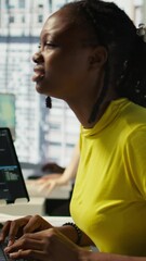 Poster - vertical video tired african american programmer having strained eyesight from overworking in office