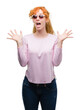 © Krakenimages.com - Young redhead woman wearing sunglasses very happy and excited, winner expression celebrating victory screaming with big smile and raised hands