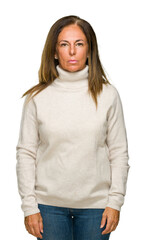 Wall Mural - beautiful middle age adult woman wearing winter sweater over isolated background with serious expres