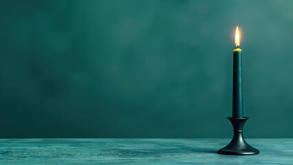 Aufkleber - Single candle burning on empty table against green background