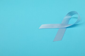 Canvas Print - Prostate cancer awareness. Light blue ribbon on color background, space for text