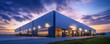 © tydeline - Modern Industrial Warehouse at Dusk with Illuminated Windows and Dynamic Cloudy Sky