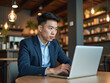 © Ali - Asian businessman typing on laptop during work in cafe