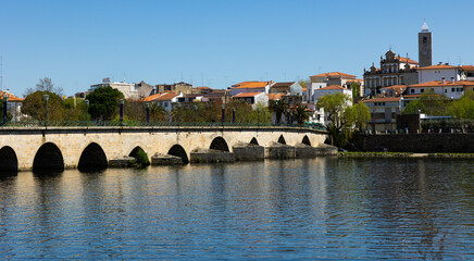 Urban landscape of city of Mirandela in the north of Portugal. Panoramic view of the banks of the river Tua with the traditional Roman bridge