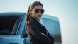 © sirisakboakaew - A female bodyguard standing next to a luxury vehicle, prepared to escort her client, with a serious and professional look