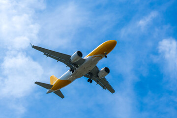 Airplane flying in the sky preparing to land at the airport. Air travel and traveling abroad