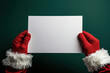 © Annamorphosis - Santa hands hold a blank white sheet