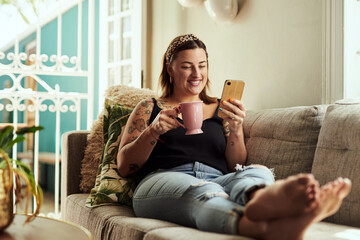 Coffee, smile and woman on sofa, smartphone and internet with social media, texting and connection. House, herbal tea and girl on couch, cellphone and typing with message to contact and communication