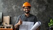© movinglines.studio - Happy and confident Indian civil engineer holding architectural plans and giving thumbs up.