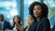 © ANDREI - Black business woman speaking at a workshop with colleagues in a conference setting