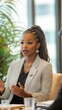 © ANDREI - Black business woman speaking at a workshop with colleagues in a conference setting