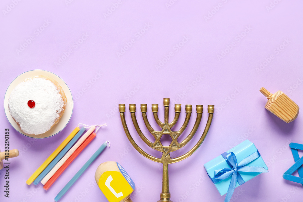Hannukah composition with menorah, dreidels, gift box and donut on lilac background