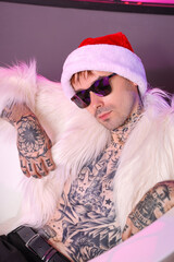 Poster - Tattooed young man with Santa hat lying in bathroom at Christmas party