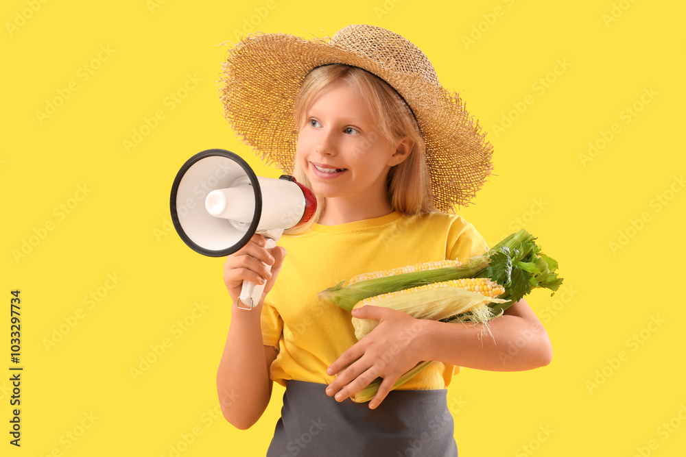 Little farmer with fresh corns and megaphone on yellow background