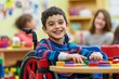 © Snowstudio - close-up of boy child in wheelchair, plays with friends at the table of special school classroom