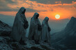 © Vovmar - Religious pilgrims in hooded cloaks stand on a mountain at sunset. Wanderer, pilgrim.