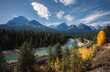 © Cavan Images - Train tracks through mountains on Morant's Curve in Banff, Canada.