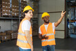 © dusanpetkovic1 - Diverse foreign workers standing at warehouse and taking about logistic and gesturing.