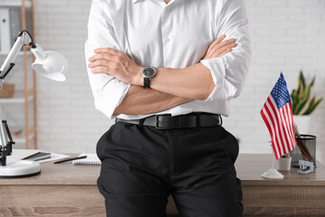 Wall Mural - Handsome young man with flag of USA in office, closeup