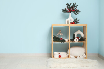 Wall Mural - Shelving unit with Christmas decoration near blue wall