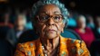 ©  Shomixer - An elderly woman with glasses, wearing an orange patterned jacket, sits attentively in an audience, exuding wisdom and a deep sense of contemplation.