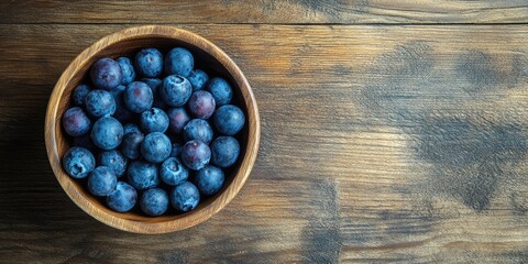 Wall Mural - Blueberries in a circular wooden bowl on a wooden surface copy space.