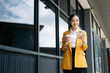 © Nuttapong punna - Young Asian business woman leader entrepreneur, professional manager holding digital tablet computer on the street