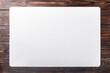 © MclittleStock - Mockup of a white textured placemat on a rustic wooden table backgroun AI-Generated.