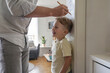 © dimedrol68 - Father placed his son near the door frame and measured his height.