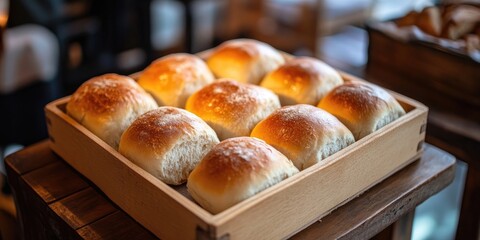 Poster - Several bread rolls are arranged in a wooden tray.