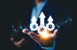 © Supatman - Process improvement and productivity growth concept. A businessman holds gears and upward arrows, symbolizing process optimization, productivity growth, efficient processes, and business efficiency.