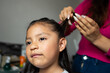 © JCarlos VBrito - Detail of a happy Mexican girl being combed by her mother