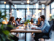 © Zahid - A blurred image of a modern office space with people working at work