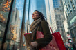 © Dennis Hoeren - Happy woman with shopping bags walking through city or mall