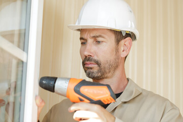 a man is drilling window