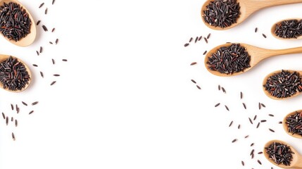 Wall Mural - Black rice in wooden spoons on a white background.