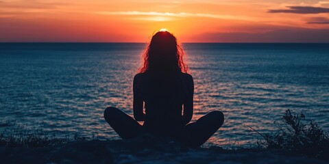 Poster - Silhouette of a woman sitting by the sea during sunset.