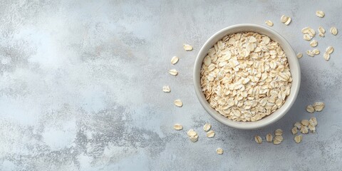 Poster - Dry oatmeal in a bowl on a light background. Healthy breakfast. Concept of dieting and weight loss. Flat lay, top view, copyspace.