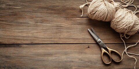 Poster - Scissors and rough cotton decorative yarn placed on a wooden background with text space.