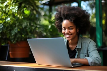 Canvas Print - Joyful african woman laptop computer typing.