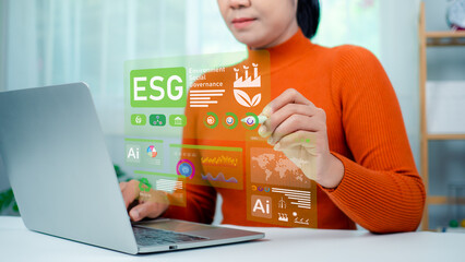 Woman hand using stylus pen to analyze ESG on screen in business investment strategy concept, ESG environment social governance investment business concept, Environmental and business growth together.