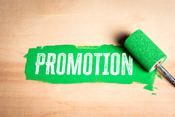 Canvas Print - Promotion. Green paint and paint roller on wood texture background