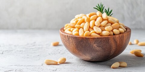 Aufkleber - Shelled Raw Pine Nuts in a Wooden Bowl, Light Background, Copy Space, shallow Depth of Field.