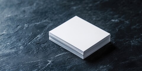 Canvas Print - A mockup featuring a stack of white business cards on a dark background, captured from above, with space for text.