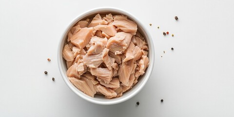 Aufkleber - Canned tuna in a white bowl, set against a white background; top view, copy space, soft lighting, studio shot.