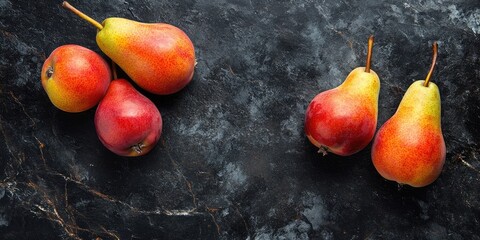 Sticker - Fresh pears on a black stone surface. Fruits. Free space for text. Top view.