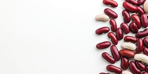 Poster - Kidney beans and red beans stacked on a white background, viewed from above with copy space.